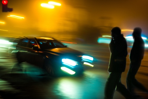 pedestrians-walking-at-night-near-traffic.jpg