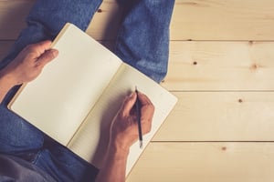 man_writing_in_notebook.jpg